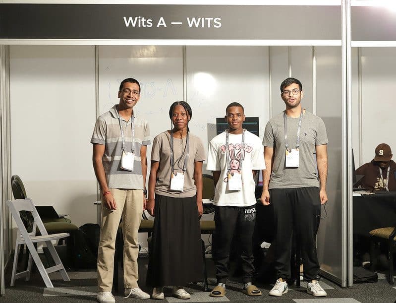 The four members of the Wits A team standing in front of their booth at the CHPC National Student Cluster Competition